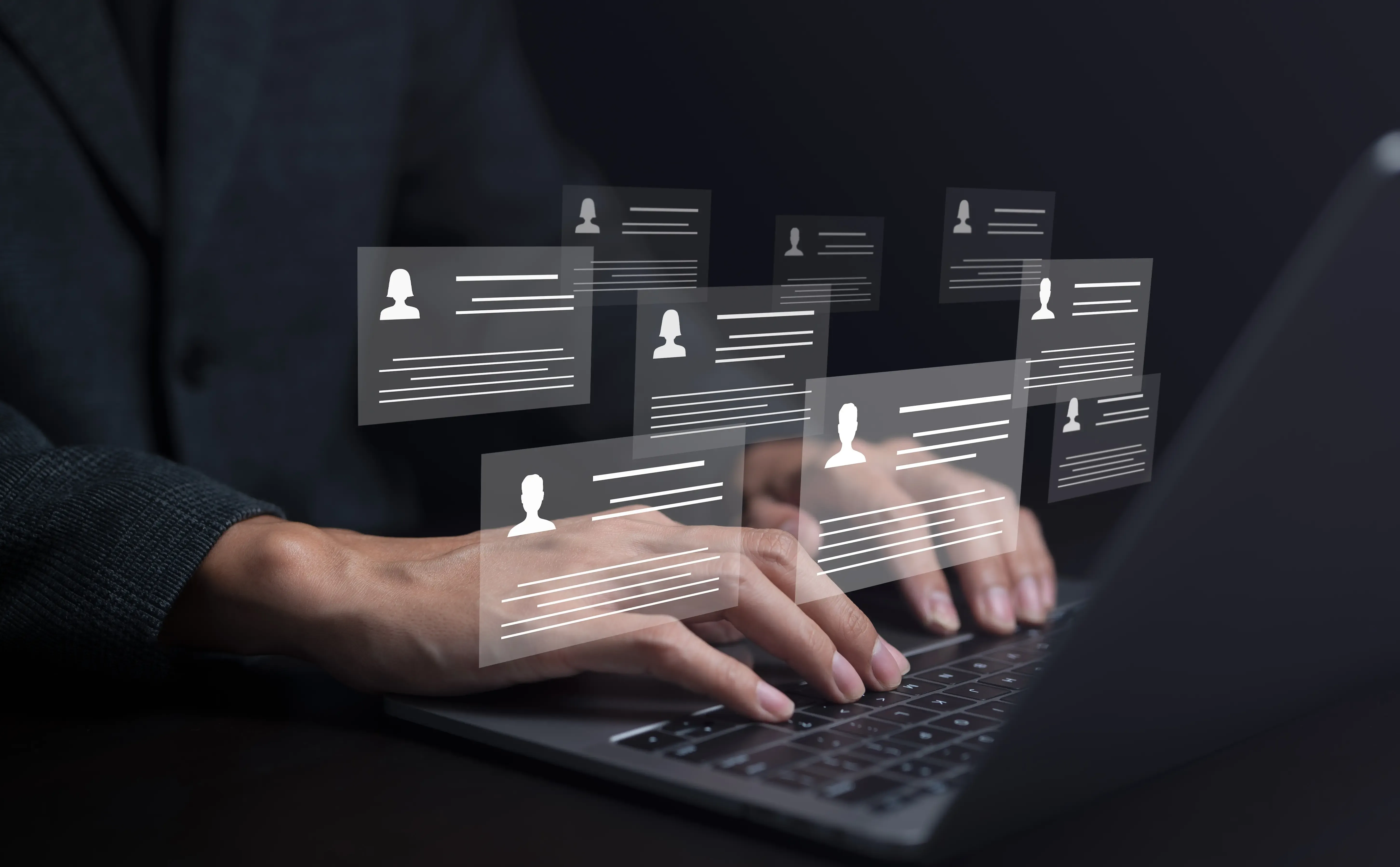 Human resource manager using computer laptop looking at many different cv resume and choosing perfect person to hire hr concept on virtual screen human resources and management concept