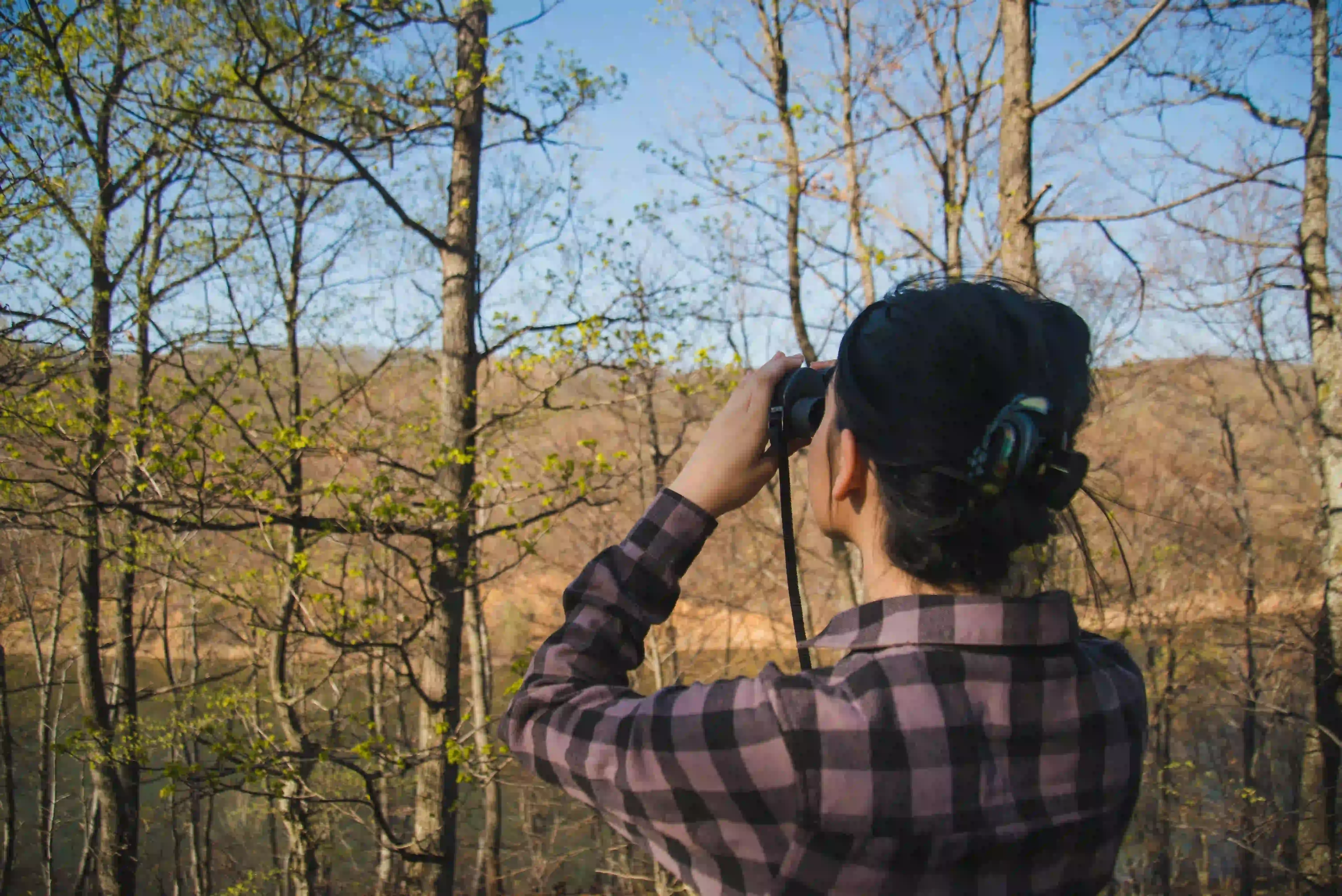 rear-view-woman-using-binoculars.webp